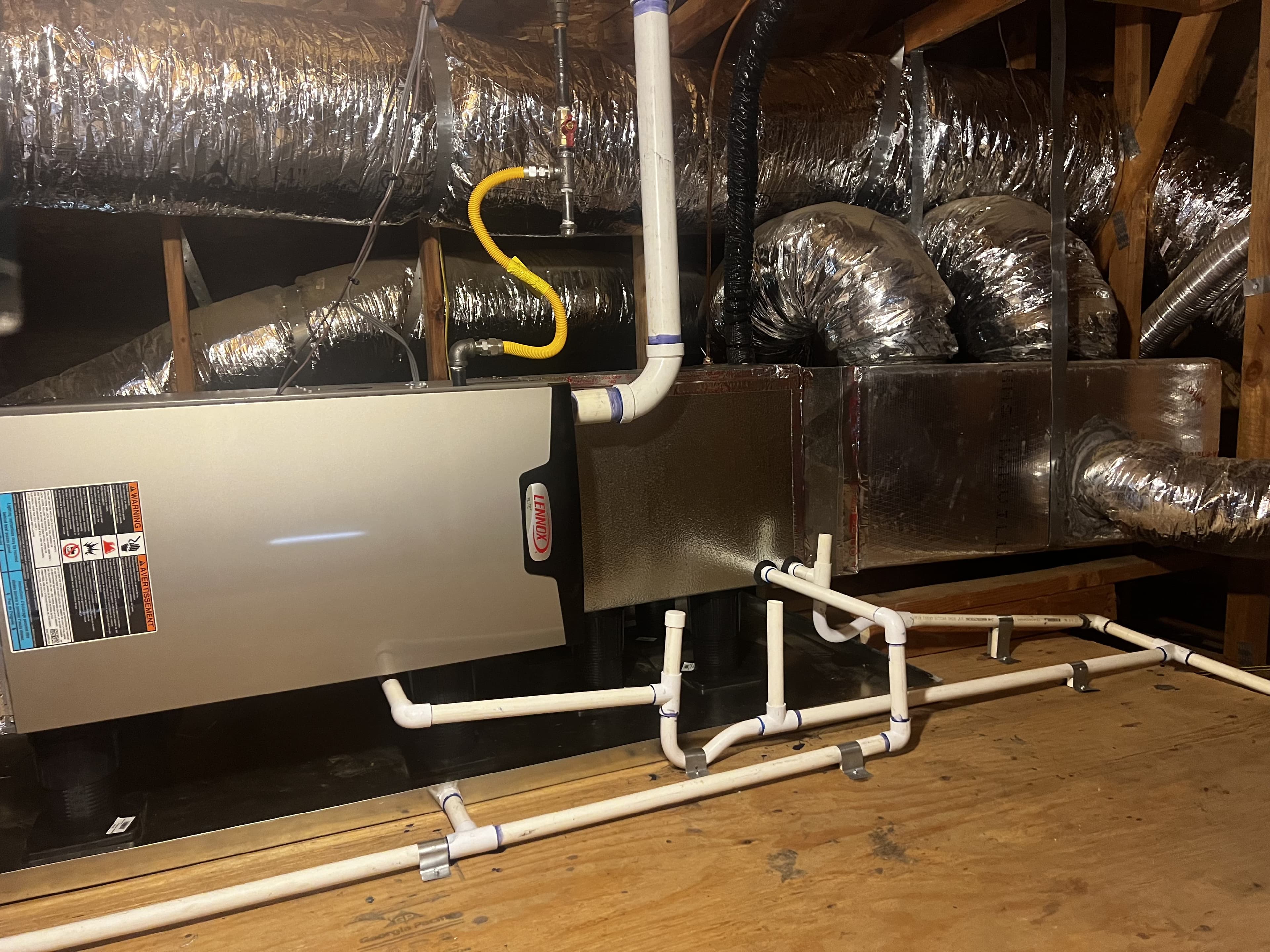 Newly installed high-efficiency Lennox furnace replacing an aging attic system