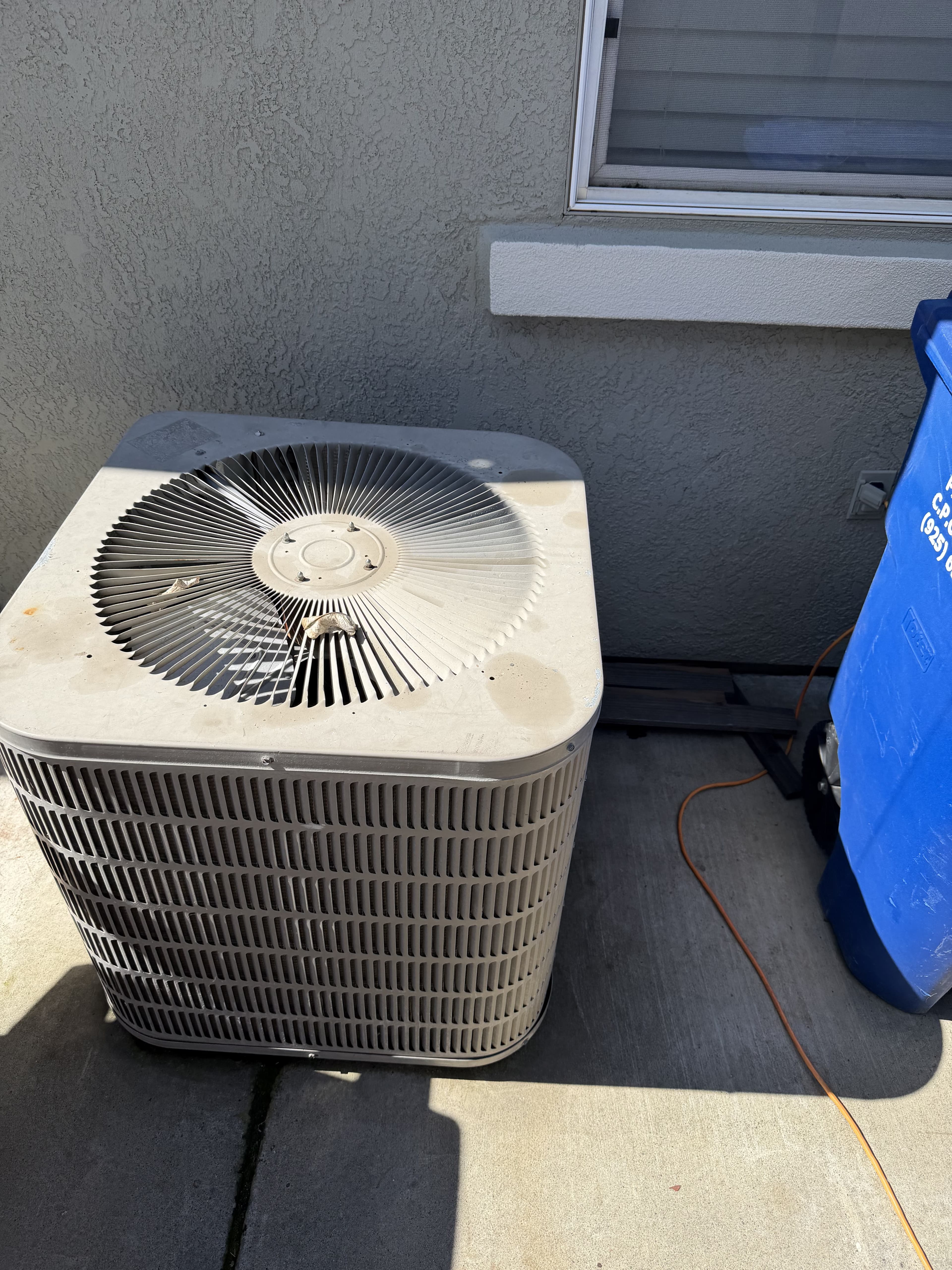 Old aging AC condenser being replaced with a modern high-efficiency unit