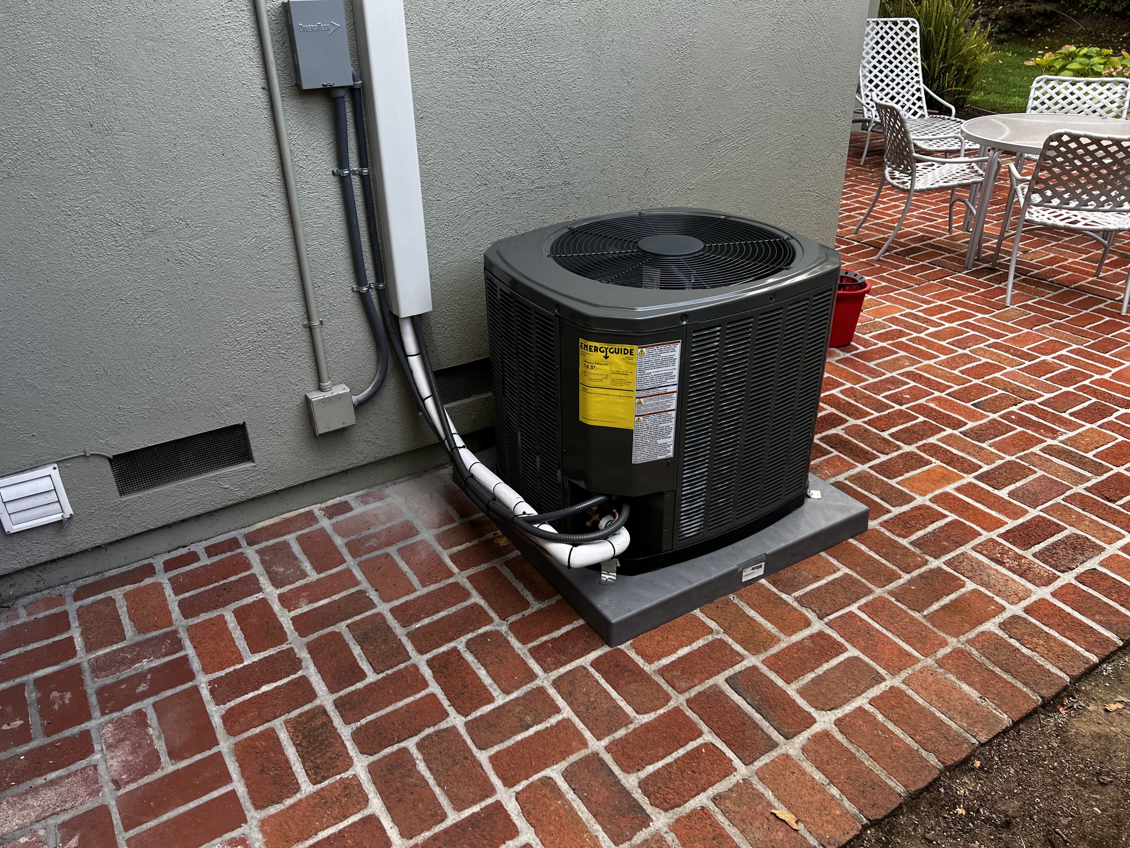 Newly installed Trane AC condenser on a brick patio
